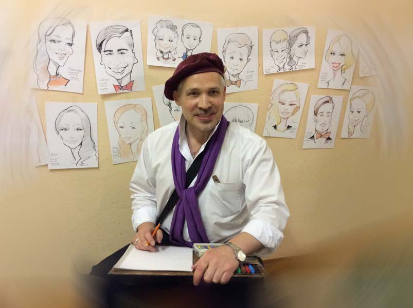 Михаил Шабалин на фоне шаржей свадьба и выпускной Чижовка